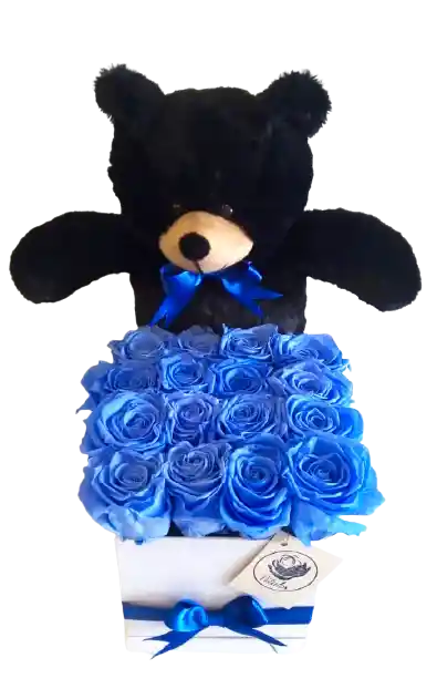 Caja deluxe blanca con rosas preservadas azules con oso de peluche negro